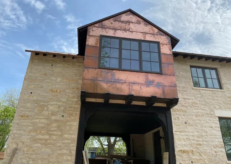 Copper metal panel facade on a stone building for Skylight Installation in Massena