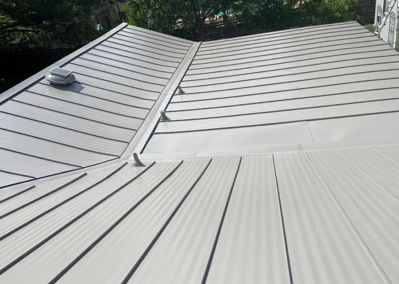 Solar attic fan installed on a metal roof for Roof Ventilation in Massena